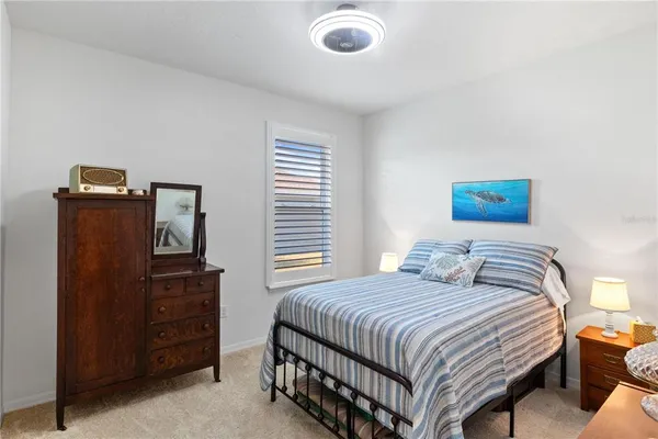 a bedroom with a bed and a television