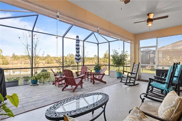 a living room with furniture and floor to ceiling windows