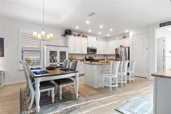 a dining room with furniture a window and kitchen view