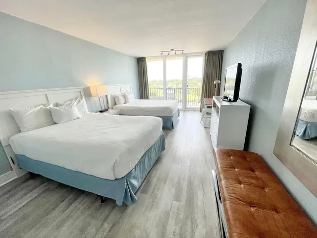 a bed room with a bed window and wooden floor