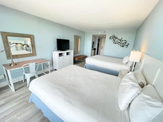 a buildings with palm trees in front of it