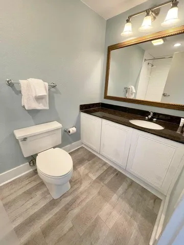 a kitchen with granite countertop a sink stove and refrigerator