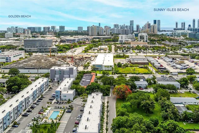 an aerial view of a house with garden space and street view