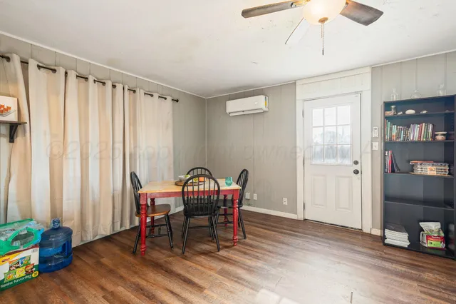 a view of a room with furniture and wooden floor