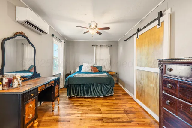 a bedroom with a bed and a dresser