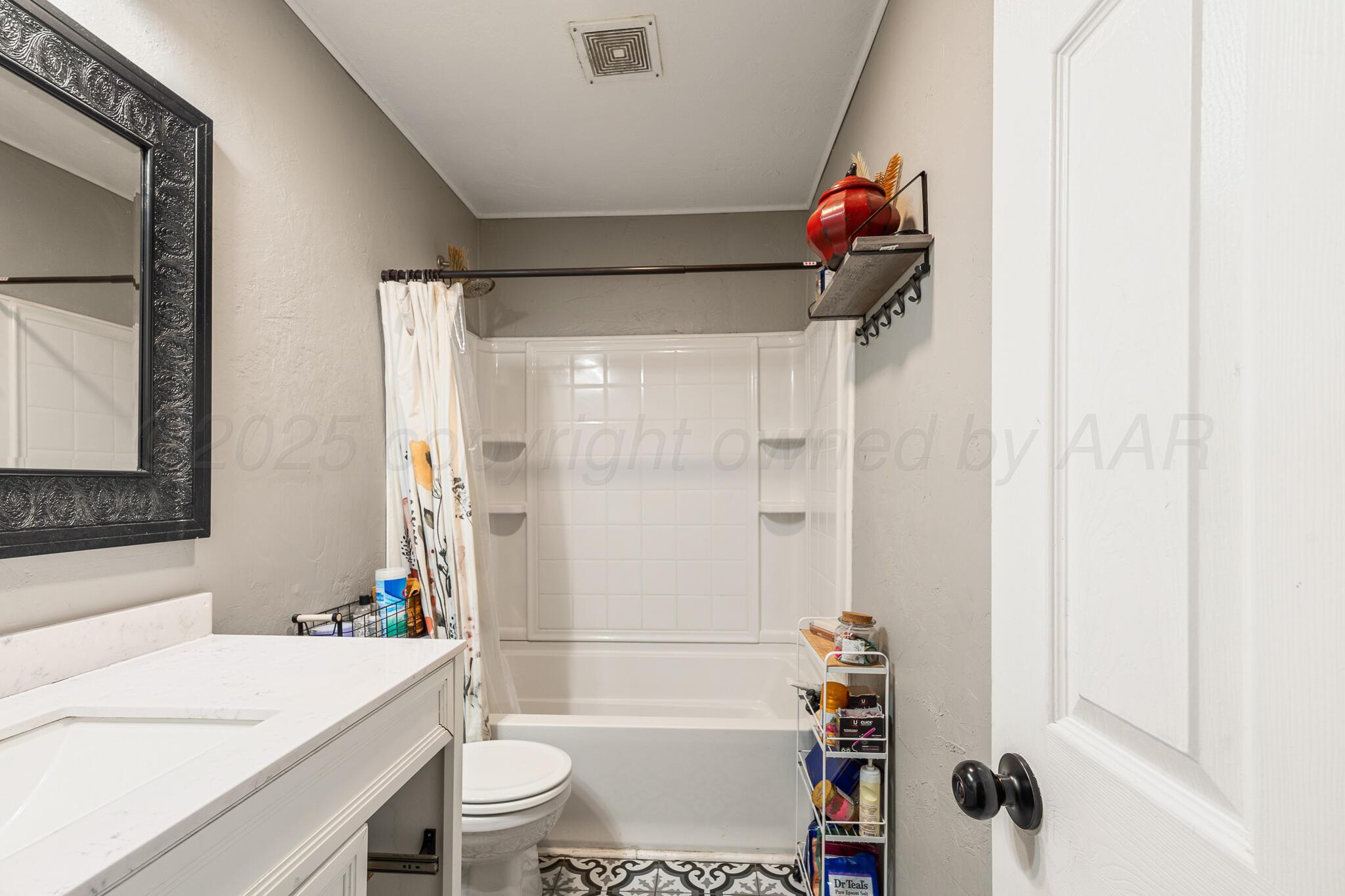 4607 Parker Street Amarillo, TX 79110 - Photo 8 of 11 a bathroom with a sink toilet and shower