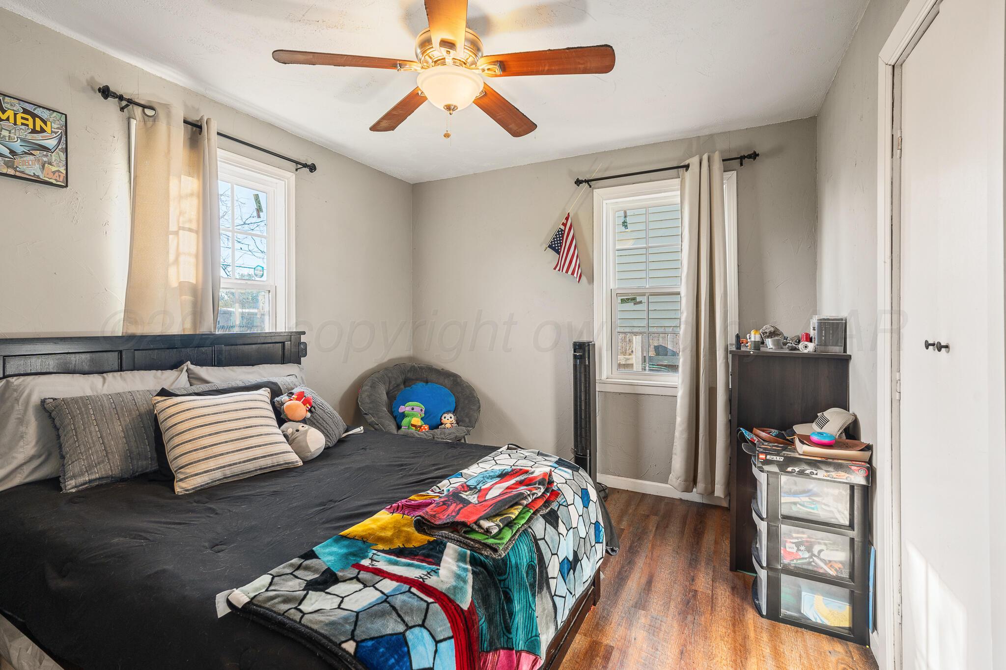 4607 Parker Street Amarillo, TX 79110 - Photo 9 of 11 a bedroom with furniture and a bed