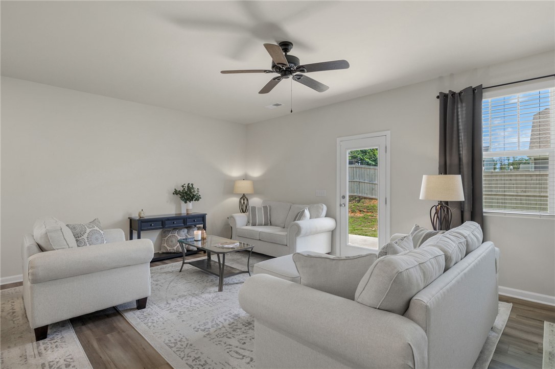 432 Bee Cv Way Pendleton, SC 29670 - Photo 14 of 39 This living area offers a harmonious blend of comfort and style, with easy access to outdoor space.