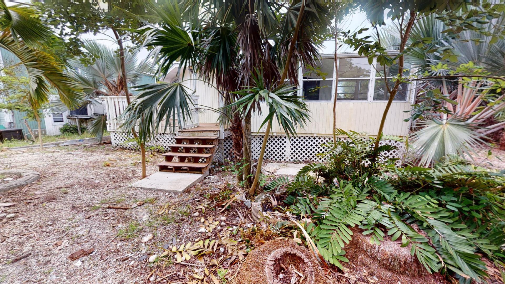 29188 Tulip Lane Big Pine Key, FL 33043 - Photo 2 of 26 a front view of a house with a yard