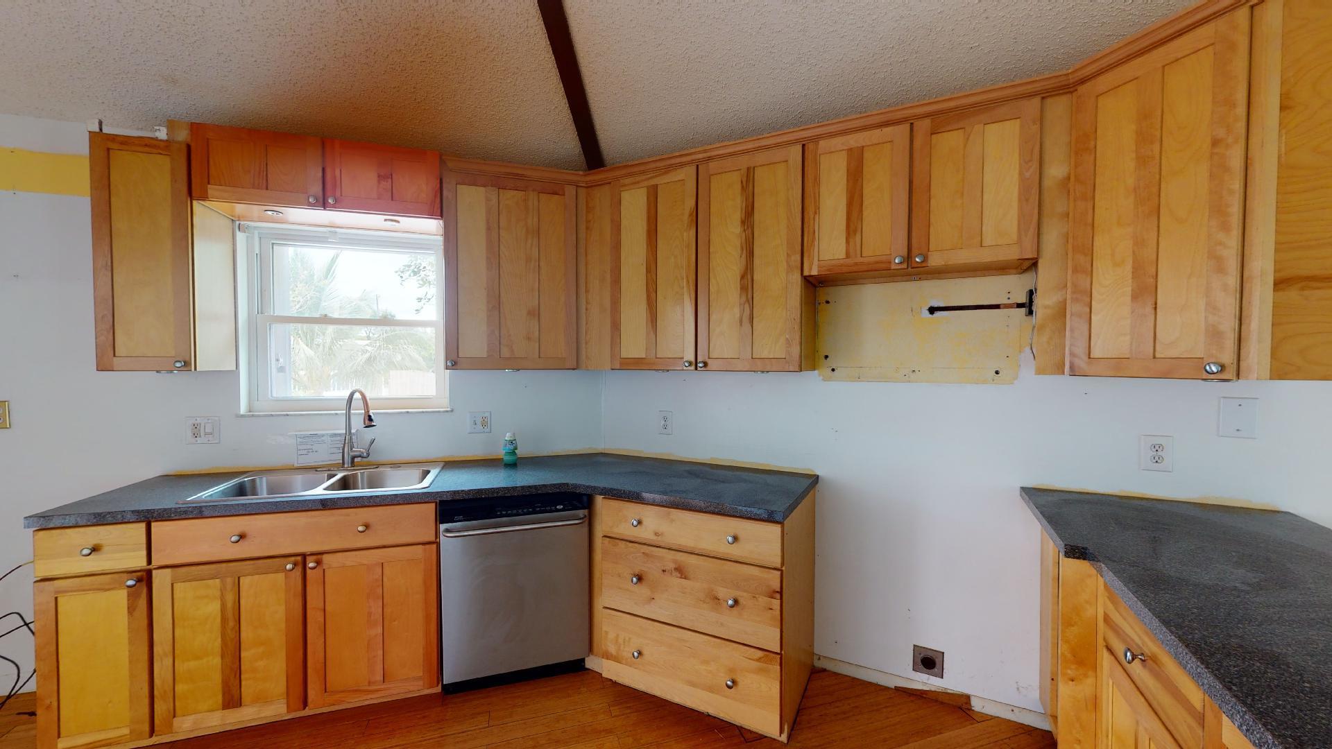 29188 Tulip Lane Big Pine Key, FL 33043 - Photo 13 of 26 a kitchen with stainless steel appliances a sink a stove and a refrigerator