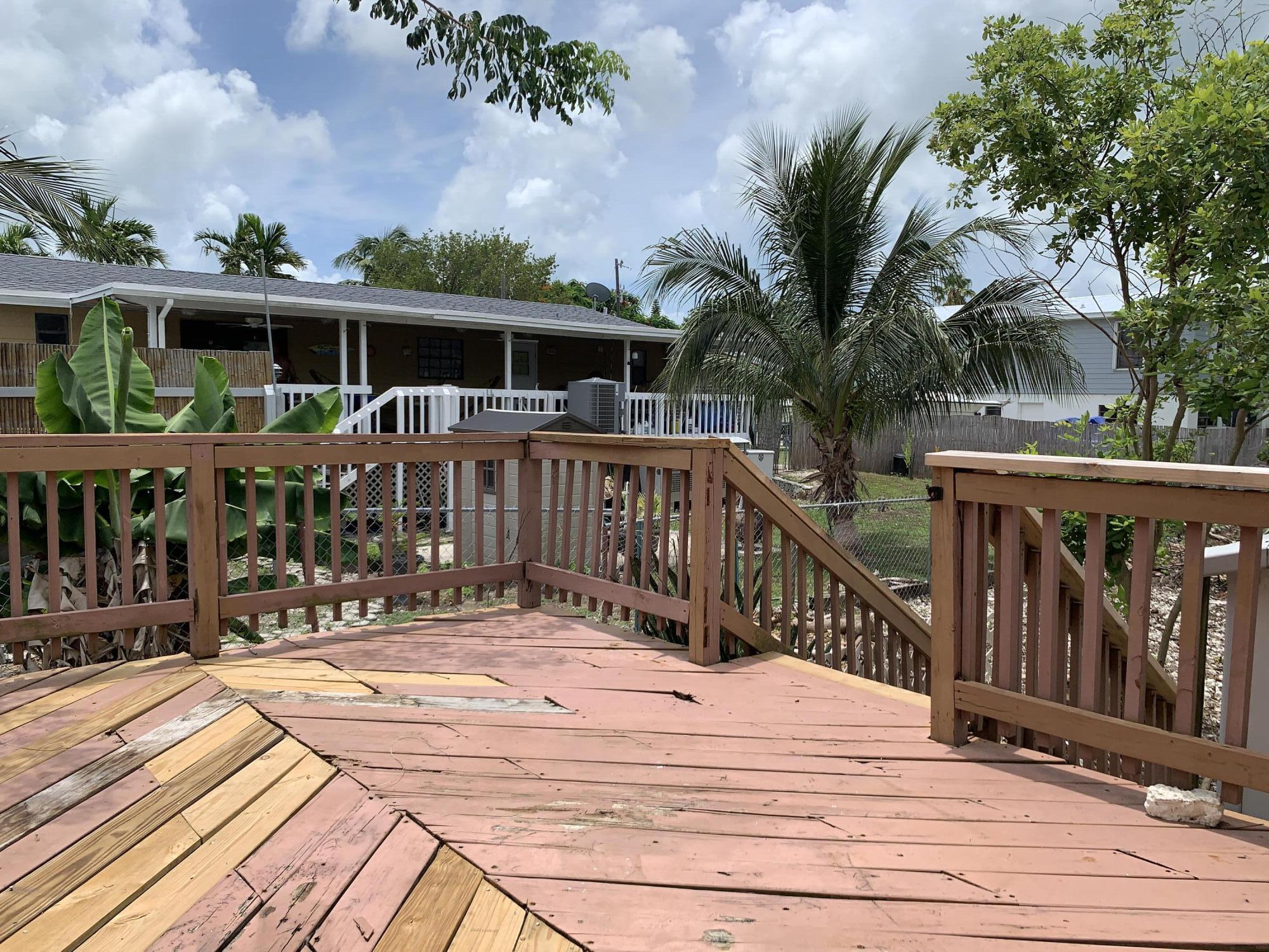 29188 Tulip Lane Big Pine Key, FL 33043 - Photo 24 of 26 a view of a house with wooden deck and furniture