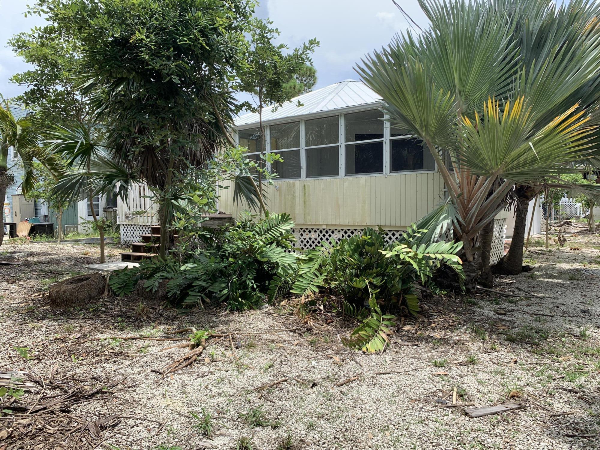 29188 Tulip Lane Big Pine Key, FL 33043 - Photo 4 of 26 a view of front of house with a garden