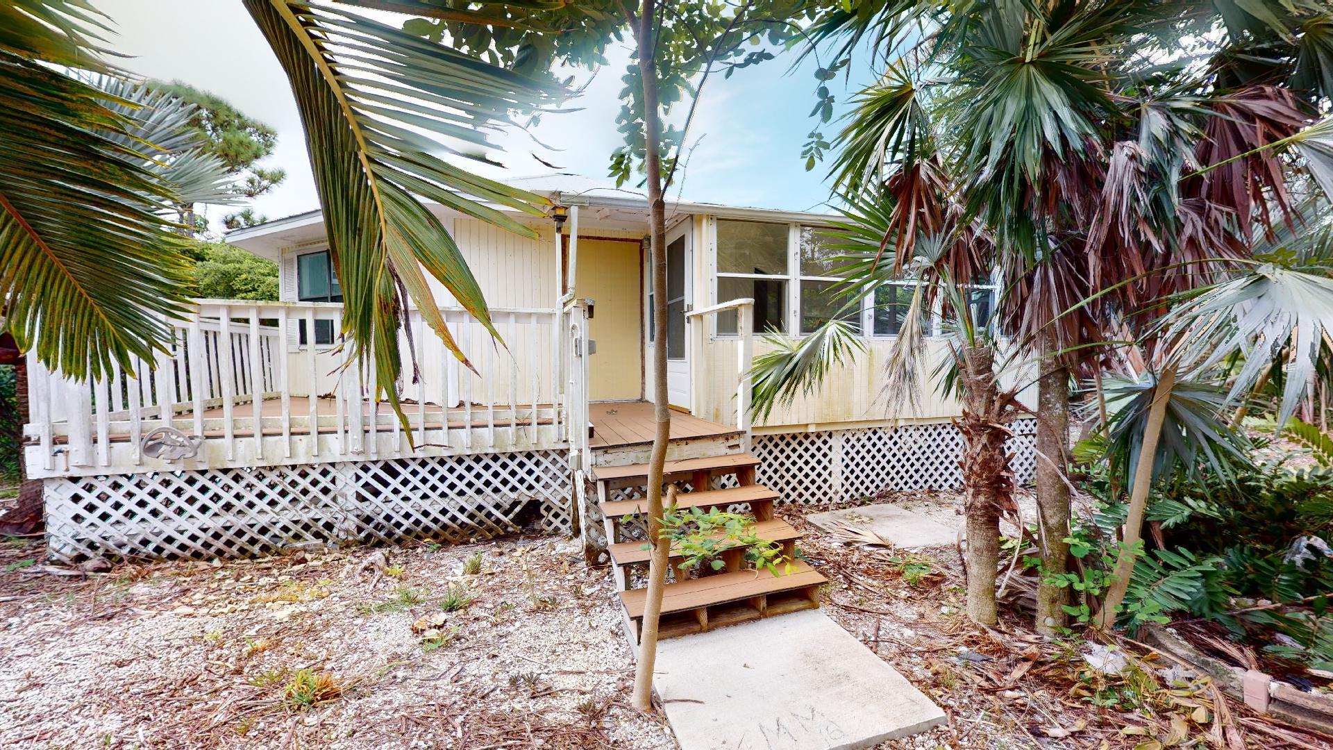 29188 Tulip Lane Big Pine Key, FL 33043 - Photo 7 of 26 a view of a brick house with wooden fence