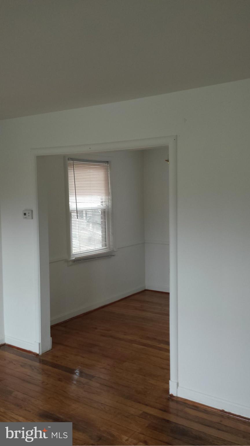 5803 3rd Street Northeast Washington, DC 20011 - Photo 2 of 20 a view of an empty room with wooden floor and a window
