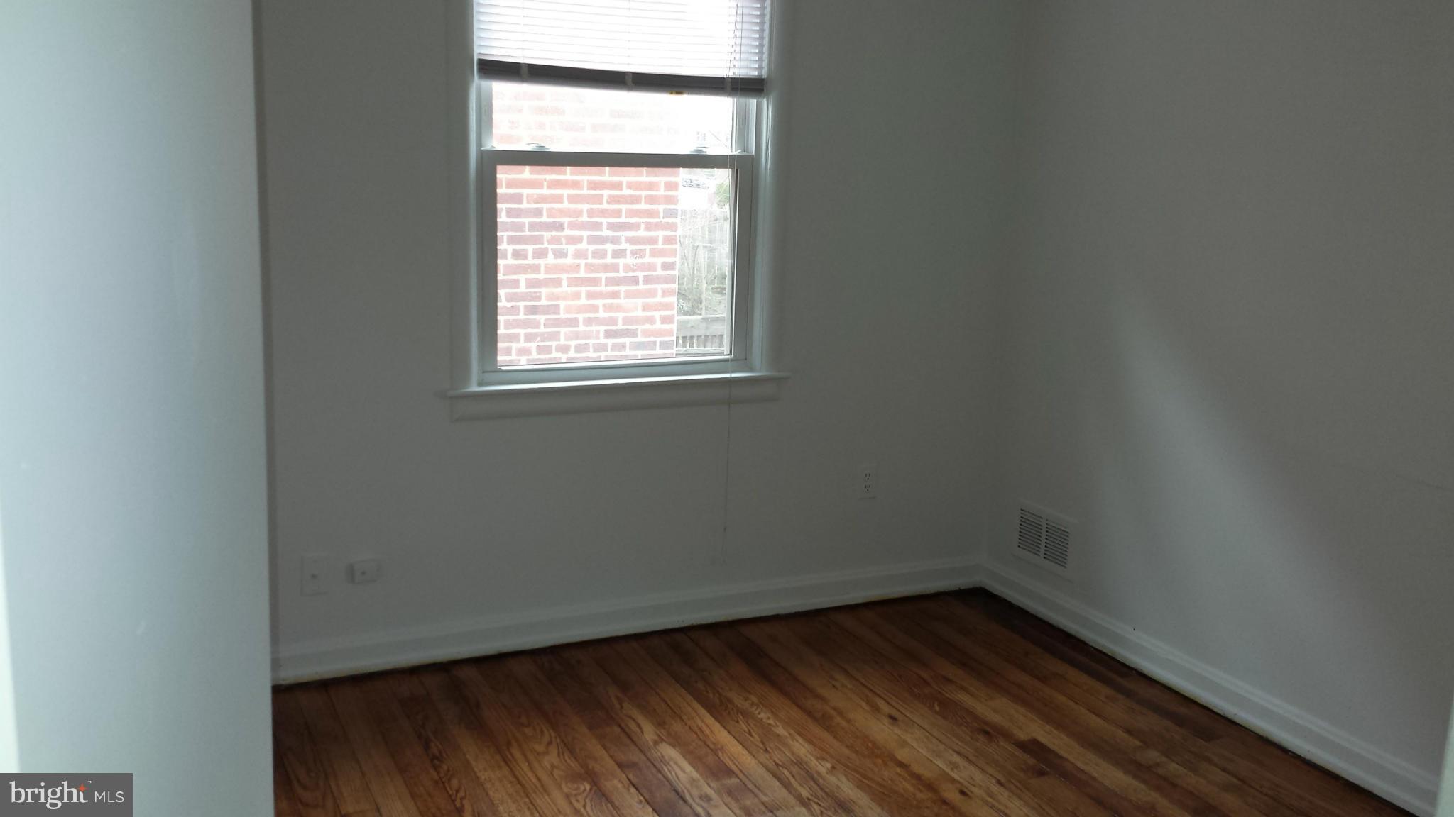 5803 3rd Street Northeast Washington, DC 20011 - Photo 13 of 20 an empty room with wooden floor and windows