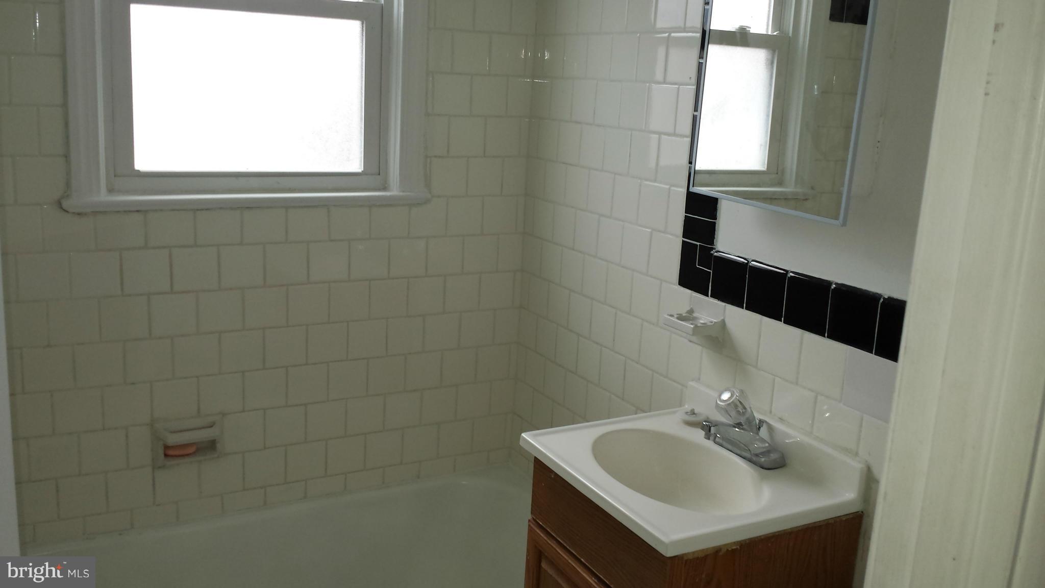5803 3rd Street Northeast Washington, DC 20011 - Photo 14 of 20 a bathroom with a sink and a mirror