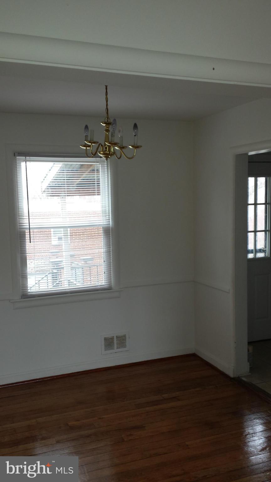 5803 3rd Street Northeast Washington, DC 20011 - Photo 3 of 20 an empty room with wooden floor and windows