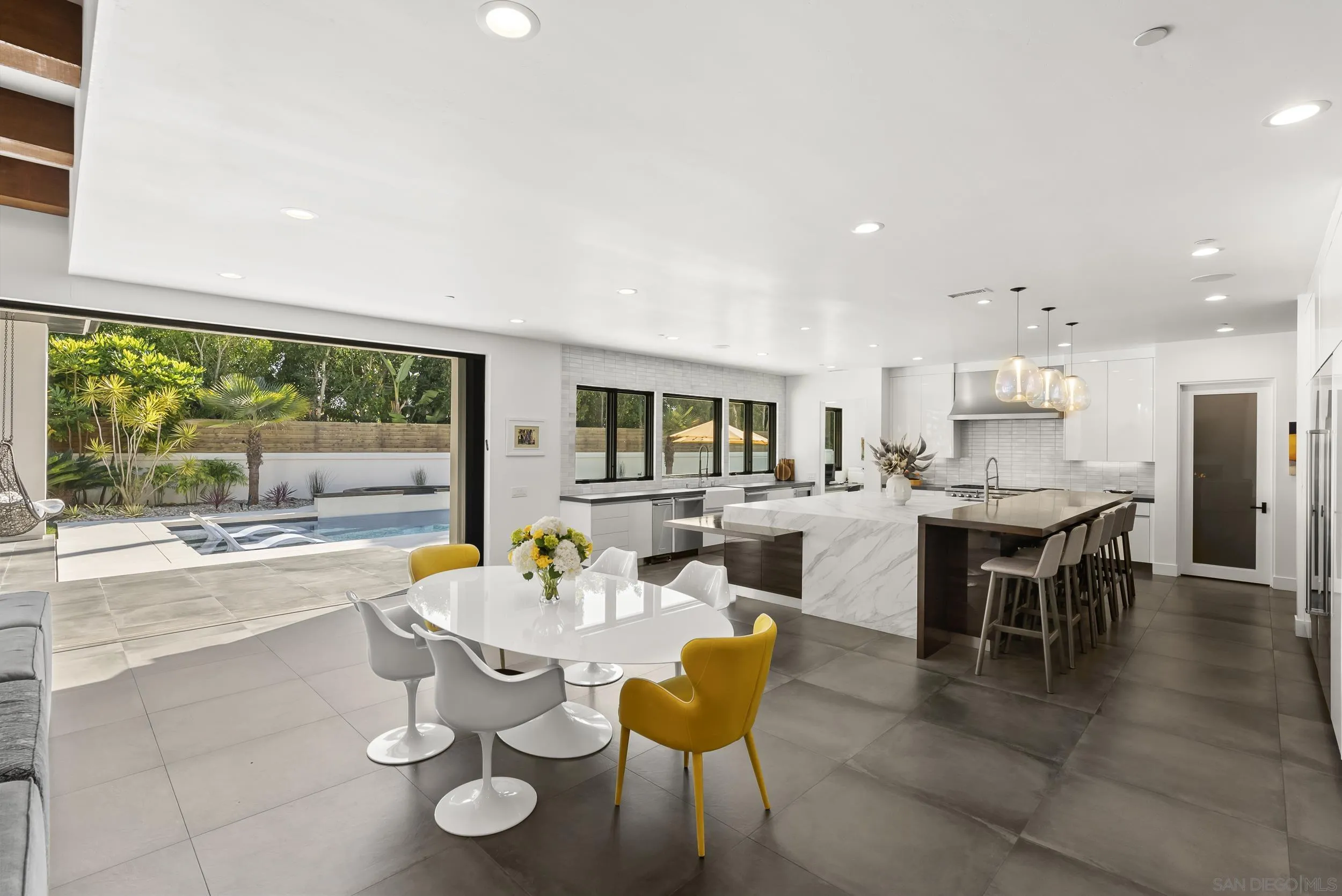 6850 Avenida De La Ronda Rancho Santa Fe, CA 92067 - Photo 12 of 40 a dining room with wooden floor a glass table and chairs