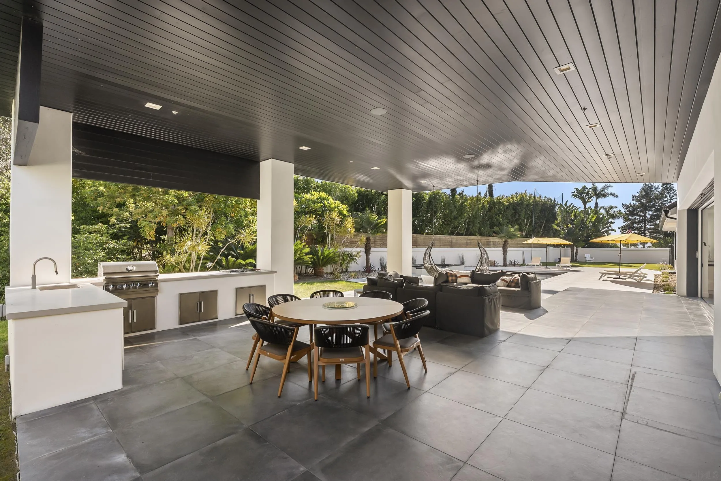 6850 Avenida De La Ronda Rancho Santa Fe, CA 92067 - Photo 29 of 40 a view of a patio with a dining table and chairs