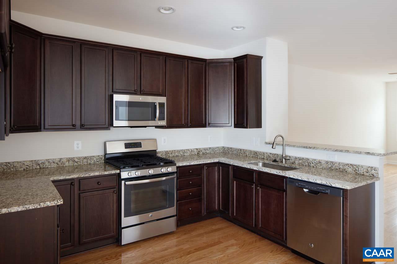 437 Rolkin Road Charlottesville, VA 22911 - Photo 7 of 26 a kitchen with granite countertop wood cabinets stainless steel appliances and a sink
