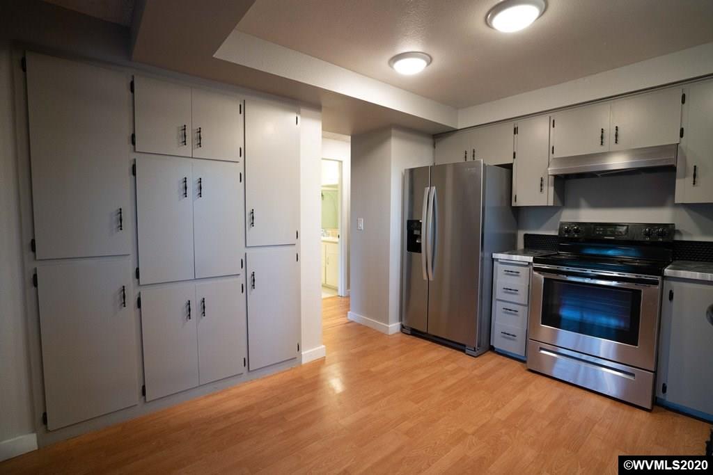 2401 Cole Road South Salem, OR 97306 - Photo 10 of 42 a kitchen with stainless steel appliances a refrigerator and a stove top oven