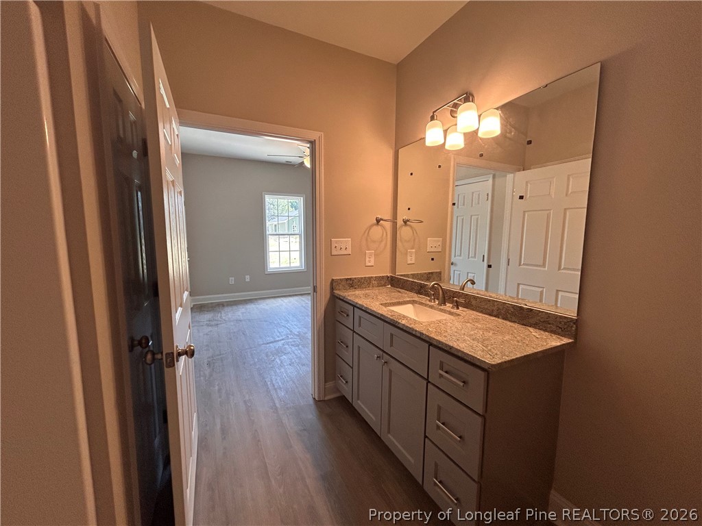 307 Elizabeth Street Spring Lake, NC 28390 - Photo 8 of 12 a bathroom with a granite countertop double vanity sink and mirror