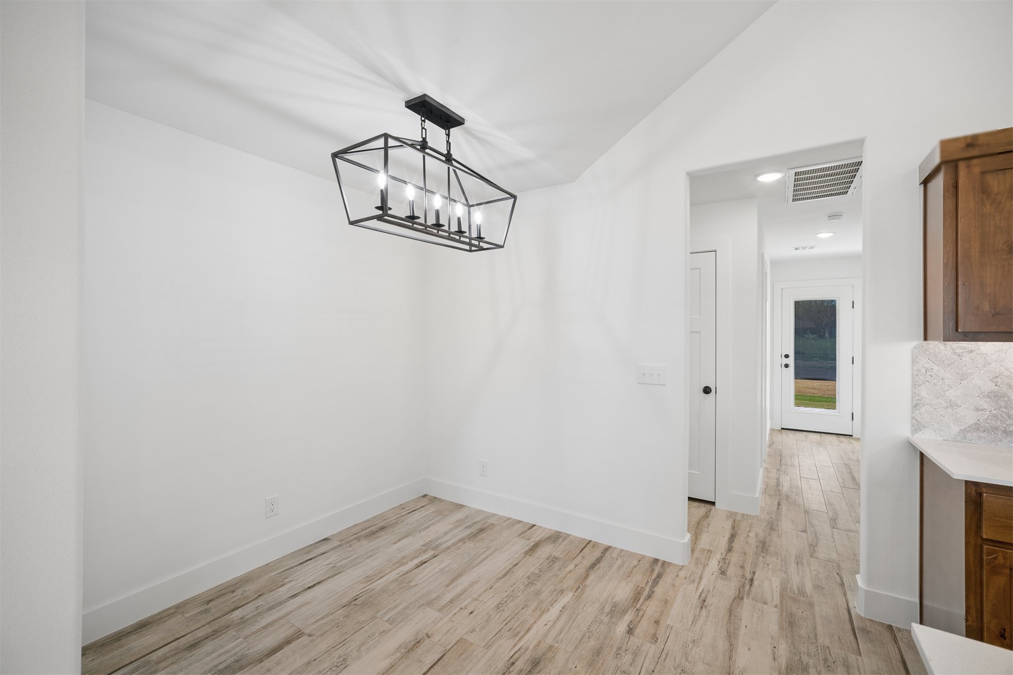 25036 South 4205 Road Inola, OK 74036 - Photo 8 of 30 Wood-finish flooring, recessed lighting, and a modern rectangular chandelier
