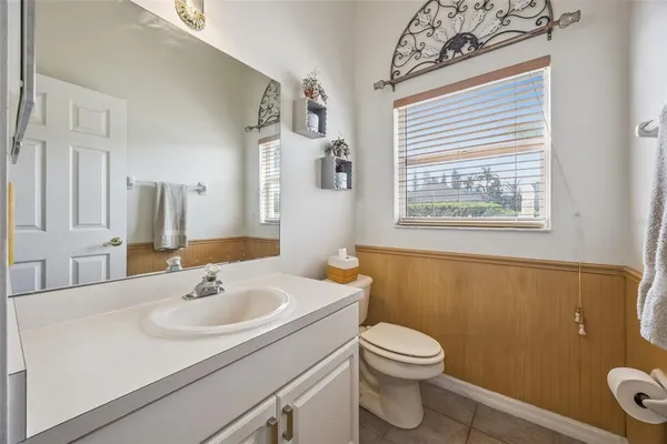 a bathroom with a sink a toilet a mirror and shower
