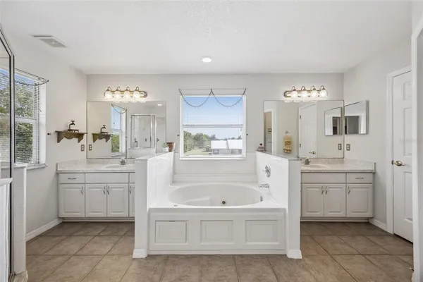 a bathroom with a granite countertop sink a mirror and a shower