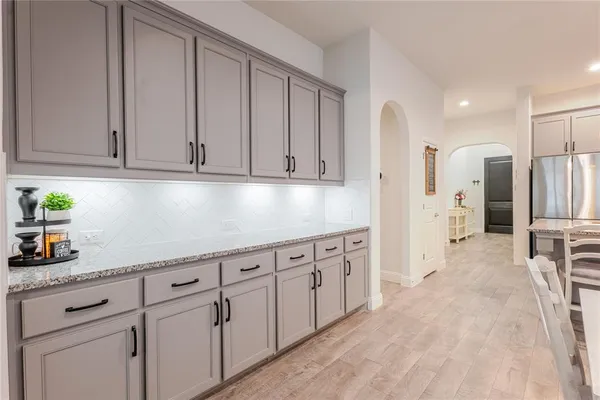 a kitchen with granite countertop white cabinets and stainless steel appliances