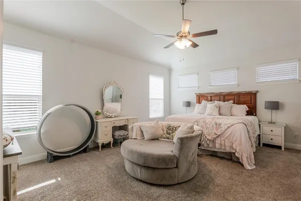 a bedroom with bed lamp and window