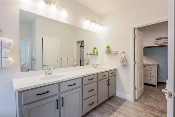a spacious bathroom with double sink and a mirror