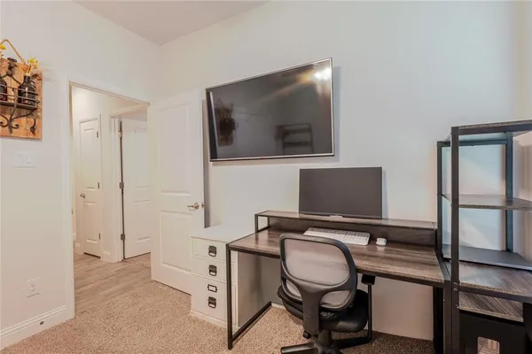 a view of a workspace with furniture and mirror