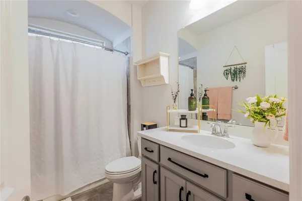 a bathroom with a sink a toilet and a mirror