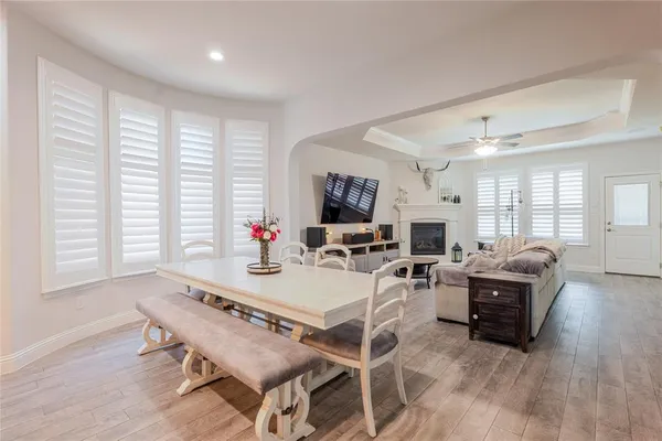 a living room with furniture a flat screen tv and a large window