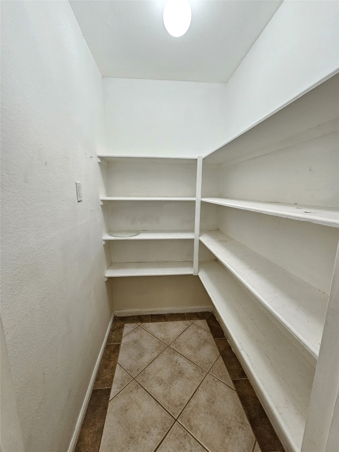 3800 Tanglewilde Street, Unit 605 Houston, TX 77063 - Photo 6 of 13 a view of a room with shelves