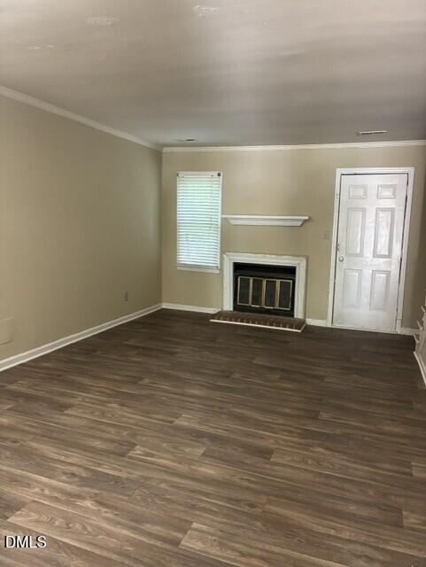 3104 Crandon Lane Raleigh, NC 27604 - Photo 5 of 10 a view of an empty room with wooden floor fireplace and a window