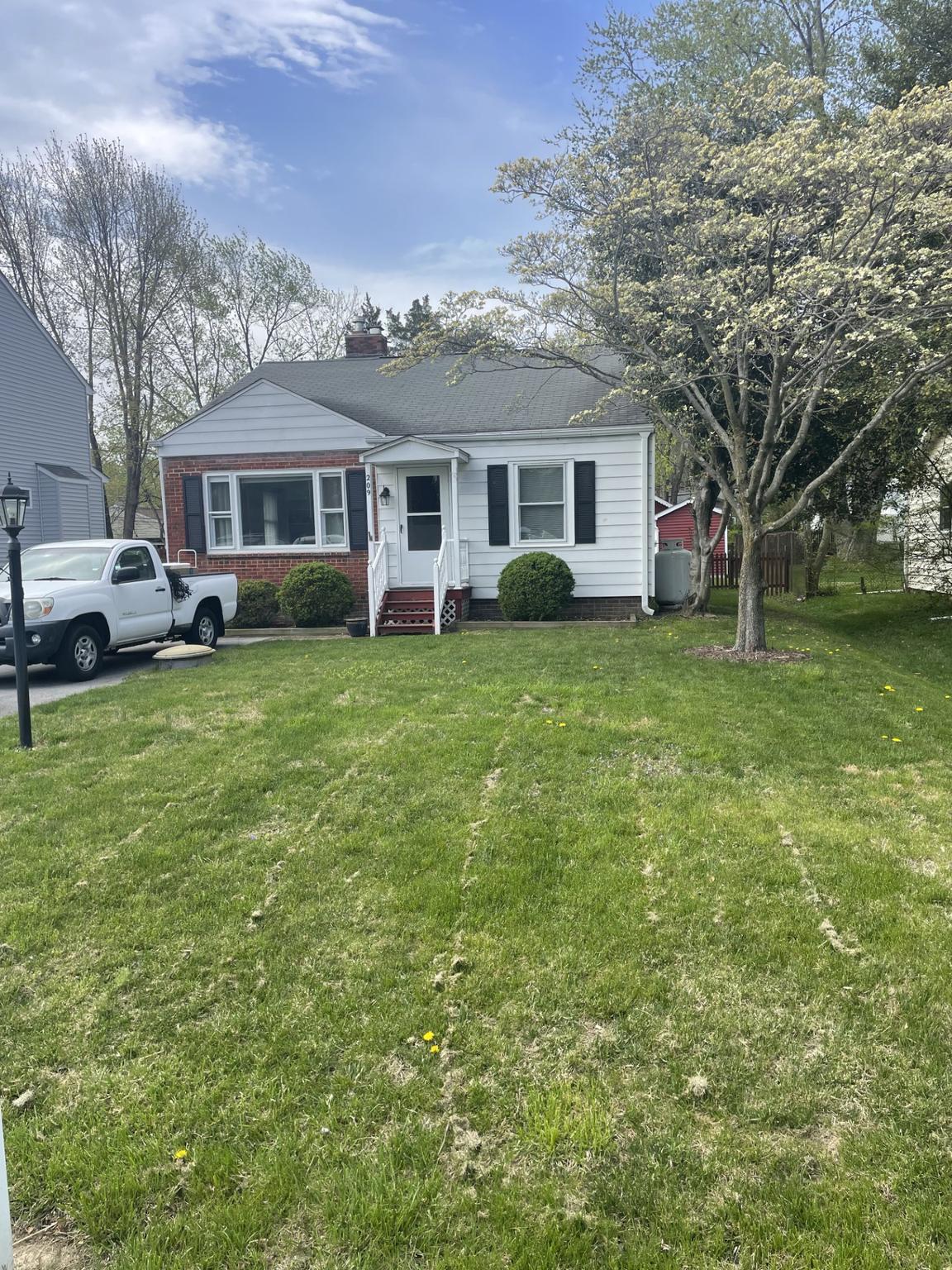 209 Beverley Avenue Edgewater, MD 21037 - Photo 1 of 13 a front view of a house with a garden and trees