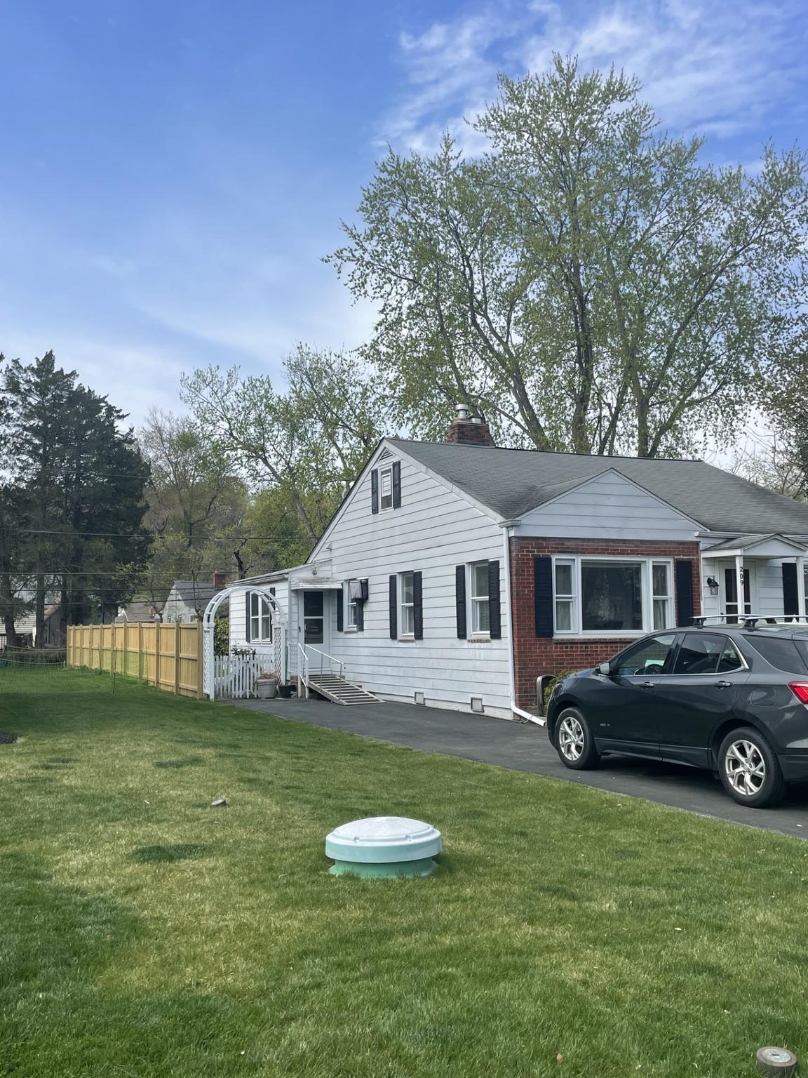 209 Beverley Avenue Edgewater, MD 21037 - Photo 2 of 13 a front view of a house with a garden and trees