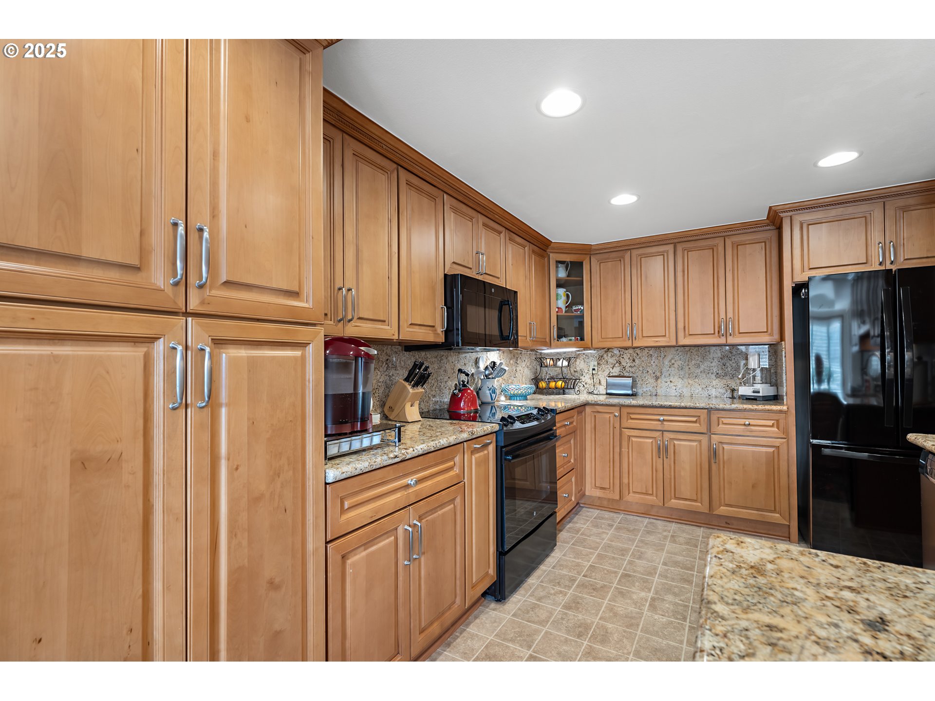 15435 Southwest 114th Court, Unit 99 Tigard, OR 97224 - Photo 13 of 40 a kitchen with granite countertop stainless steel appliances and wooden cabinets