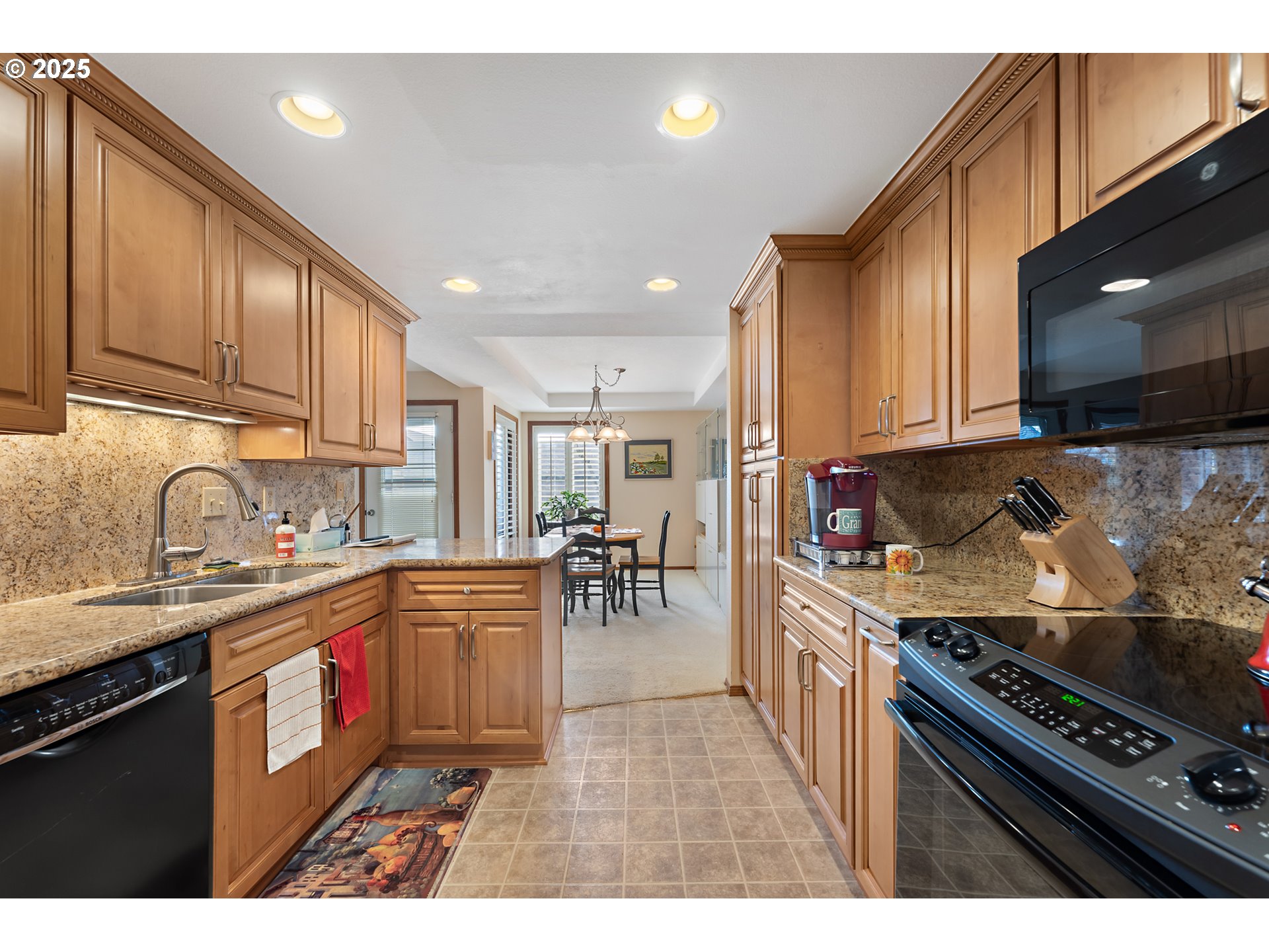15435 Southwest 114th Court, Unit 99 Tigard, OR 97224 - Photo 14 of 40 a kitchen with stainless steel appliances granite countertop a stove top oven a sink dishwasher and cabinets with wooden floor