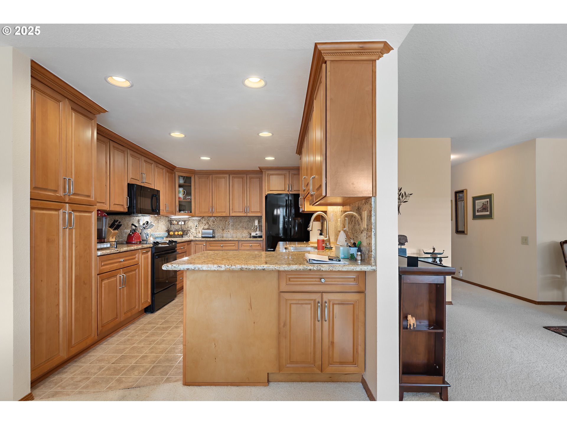 15435 Southwest 114th Court, Unit 99 Tigard, OR 97224 - Photo 16 of 40 a kitchen with kitchen island granite countertop a refrigerator oven a sink dishwasher with a dining table and chairs