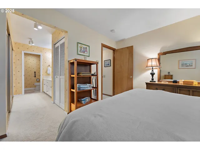 a living room with closet and view of kitchen