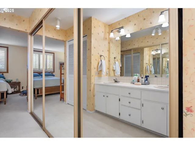 a bathroom with a double vanity sink and a mirror