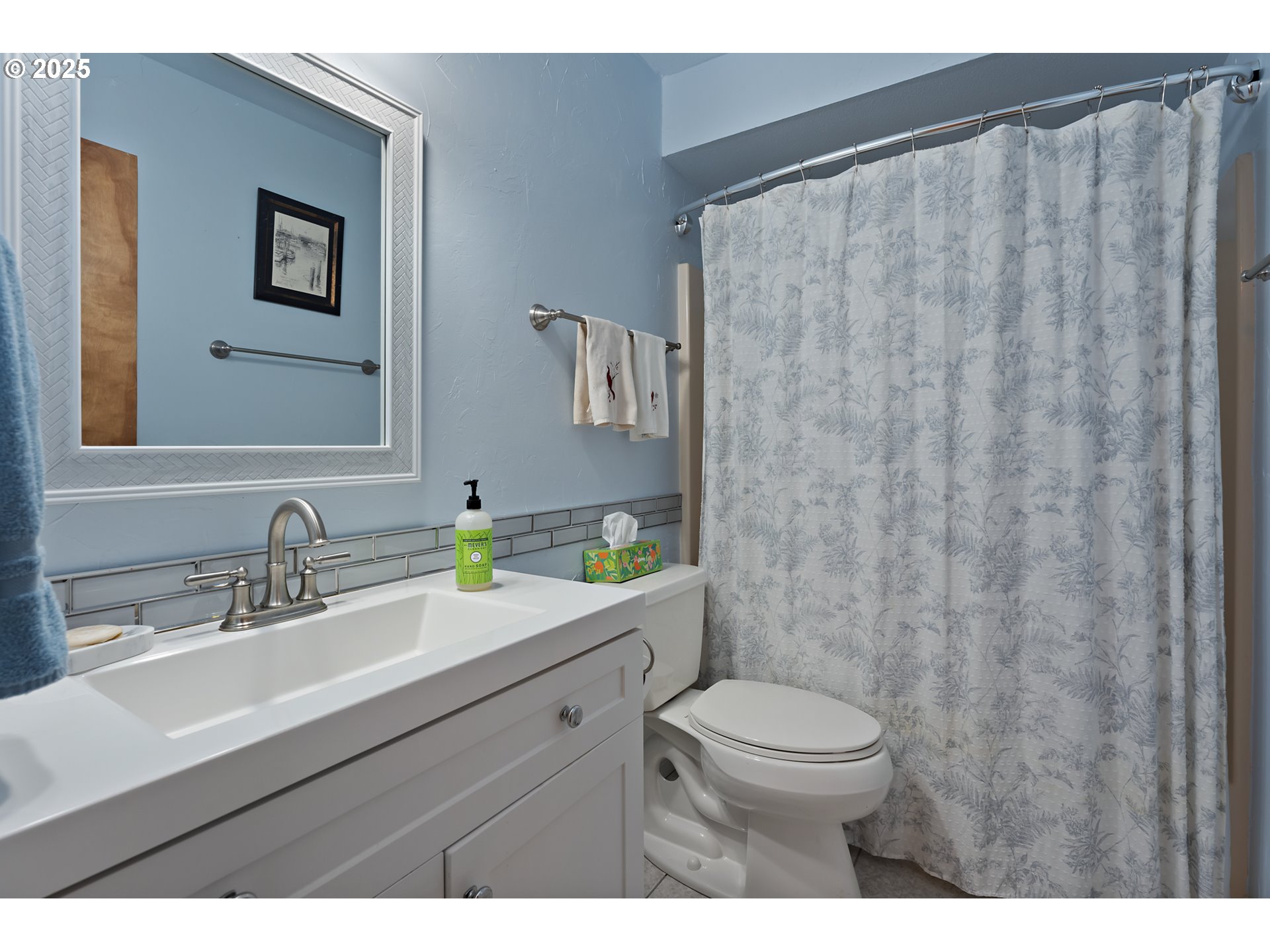 15435 Southwest 114th Court, Unit 99 Tigard, OR 97224 - Photo 25 of 40 a bathroom with a sink a toilet and a mirror