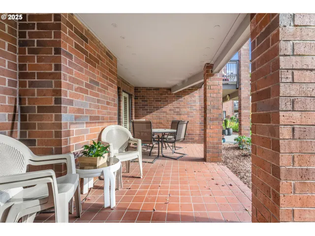 a balcony with table and chairs