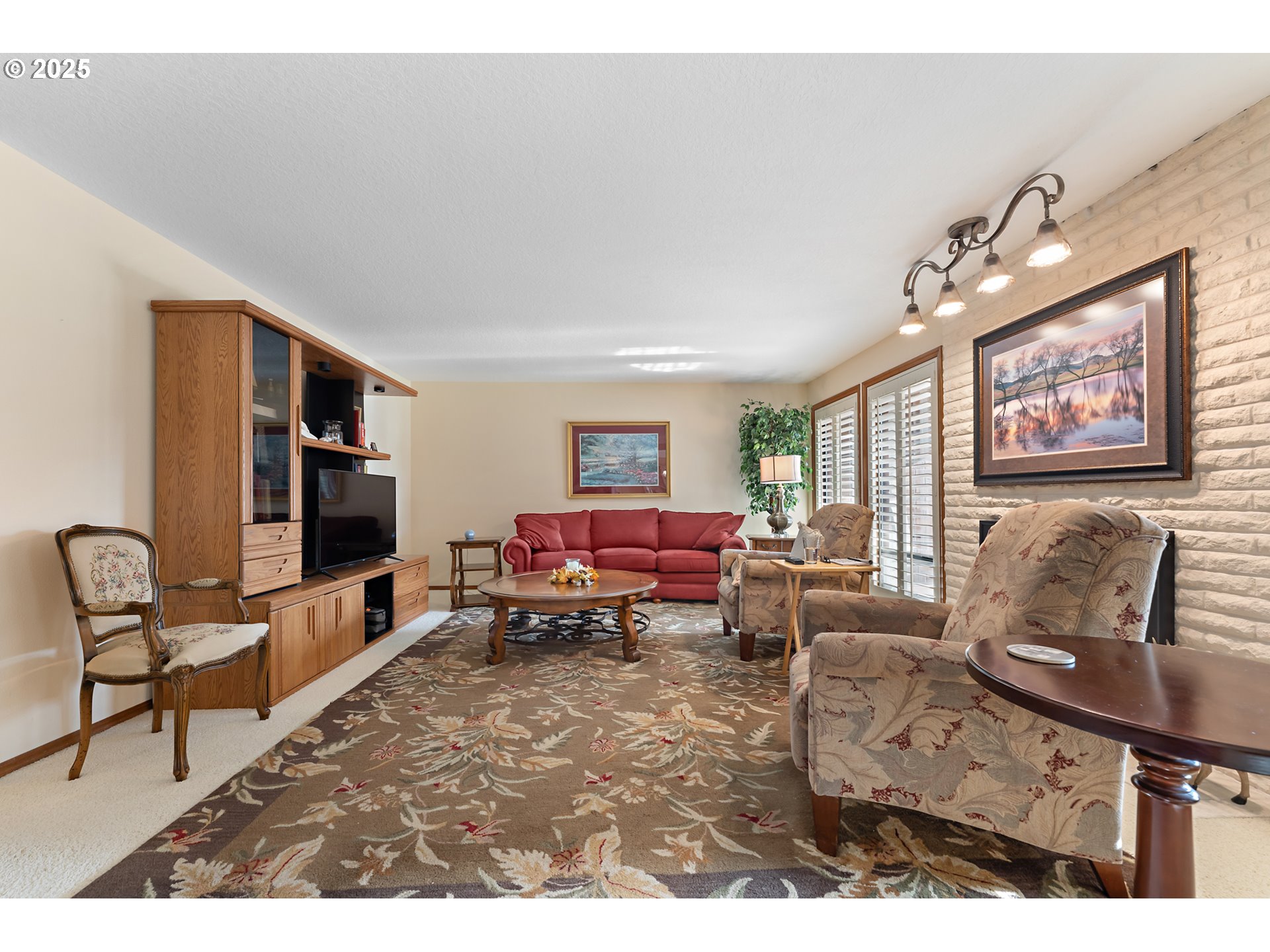 15435 Southwest 114th Court, Unit 99 Tigard, OR 97224 - Photo 3 of 40 a living room with furniture and a flat screen tv