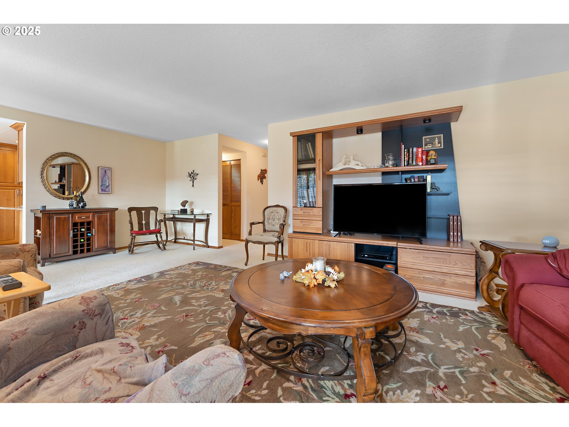 15435 Southwest 114th Court, Unit 99 Tigard, OR 97224 - Photo 6 of 40 a living room with furniture a flat screen tv and a table
