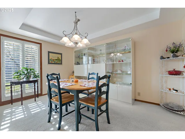 a view of a dining room with furniture and chandelier