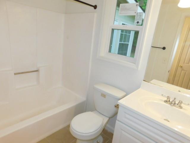 1710 Pine Road Marietta, GA 30062 - Photo 21 of 23 a white toilet sitting next to a bathroom sink and a bathtub